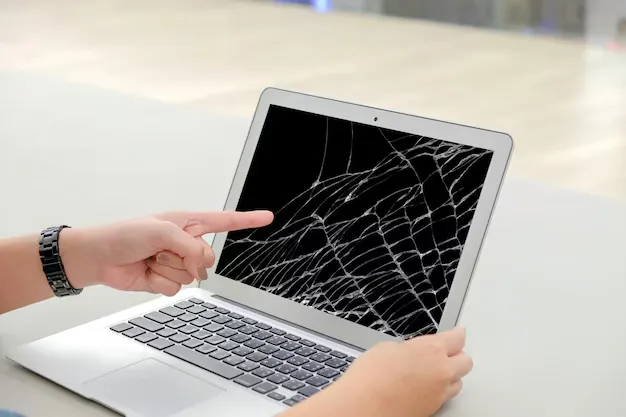 hands pointing cracked laptop screen